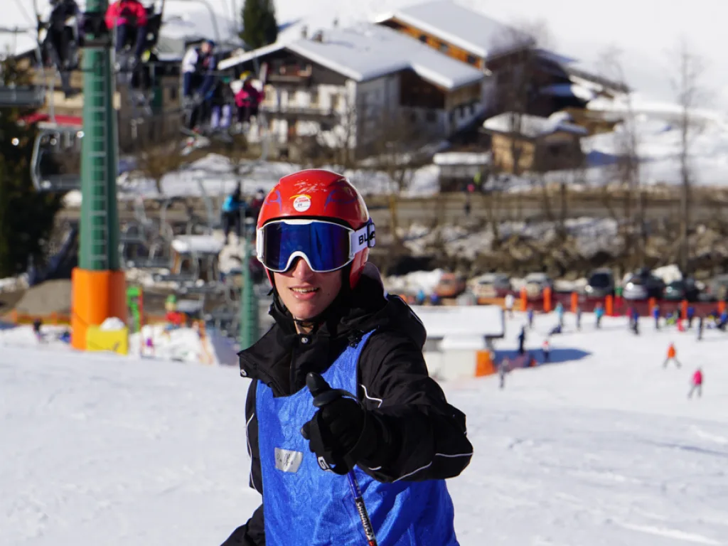 Jugendlicher mit rotem Helm auf der Piste.